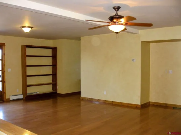 a view of a room with wooden floor