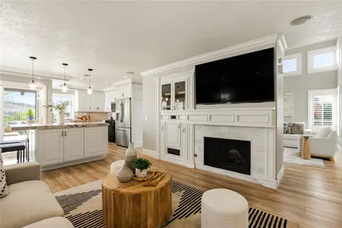 a living room with furniture a flat screen tv and a fireplace