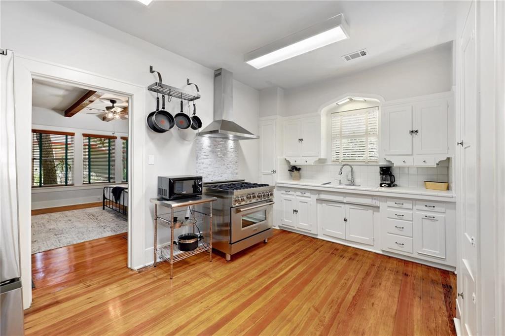 1604 South Main Street Georgetown, TX 78626 - Photo 12 of 25 a kitchen with cabinets and wooden floor