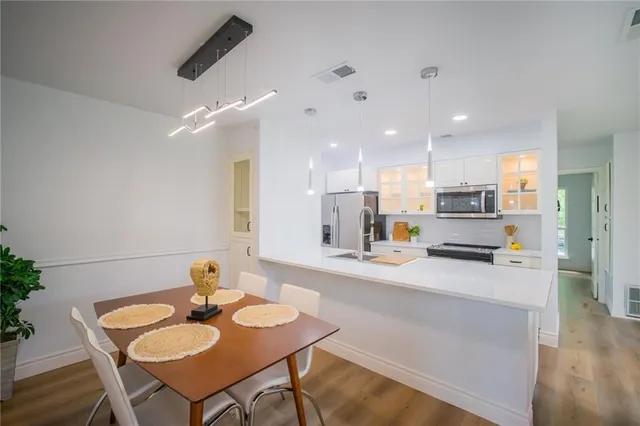 a kitchen with a sink cabinets and refrigerator