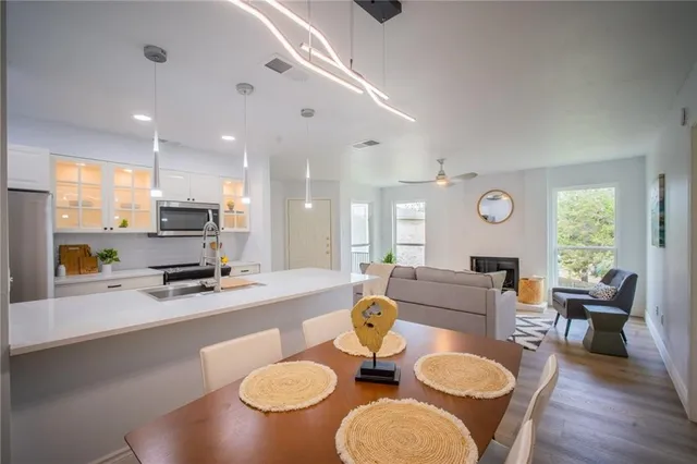 a large kitchen with a table and chairs