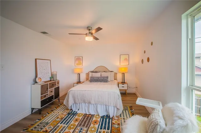 a bedroom with a bed and wooden floor