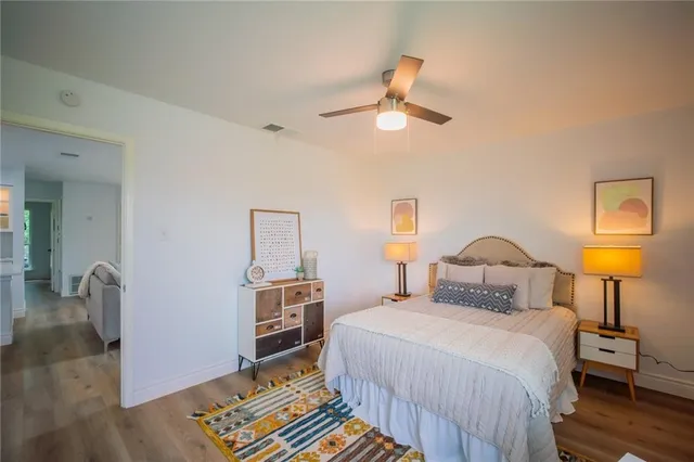 a bedroom with a bed and wooden floor