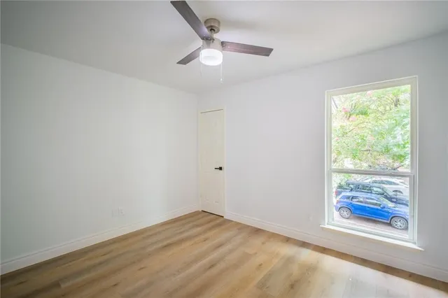 wooden floor in an empty room with a window