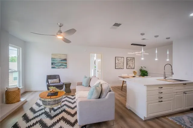 a living room with furniture and a chandelier