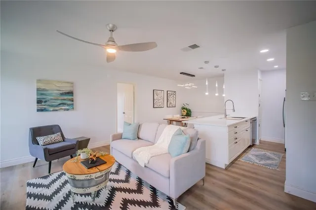 a living room with furniture and a wooden floor