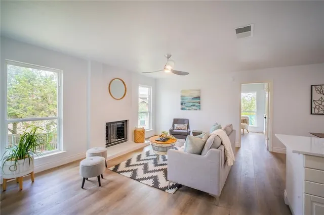 a living room with furniture fireplace and window
