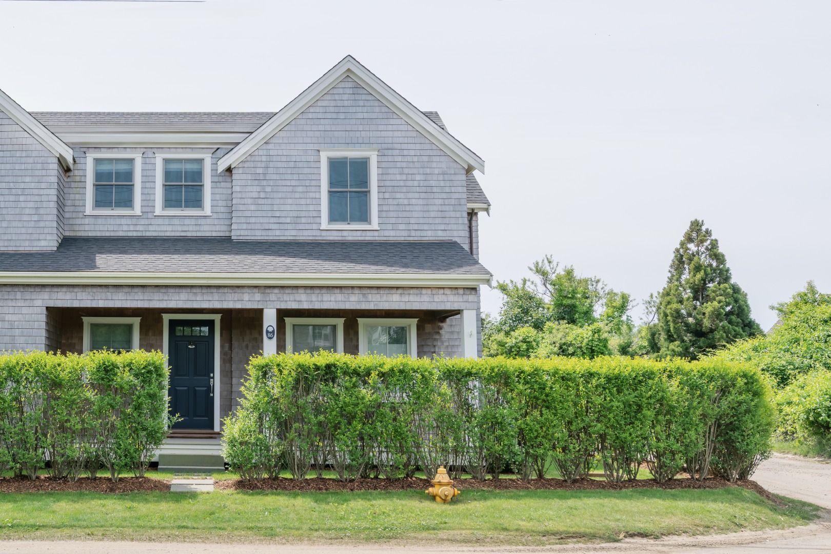 86 Cliff Road Nantucket, MA 02554 - Photo 28 of 29 a front view of a house with a yard