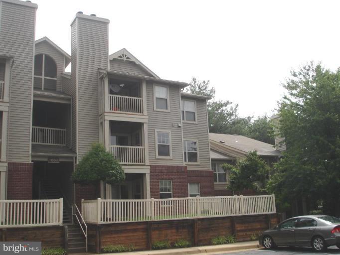 11655 Gas Light Court, Unit 11655C Reston, VA 20190 - Photo 1 of 9 a front view of a house with a yard
