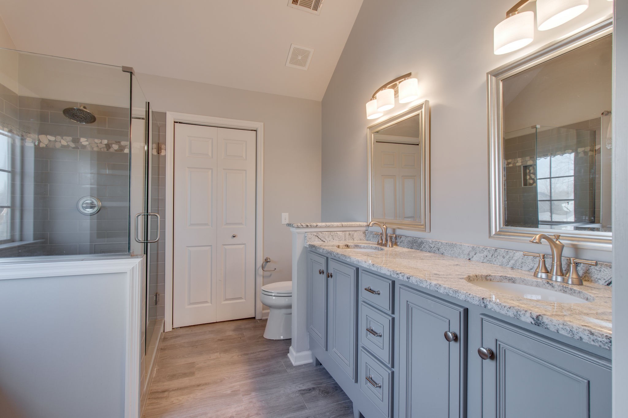 a bathroom with a granite countertop sink mirror and double