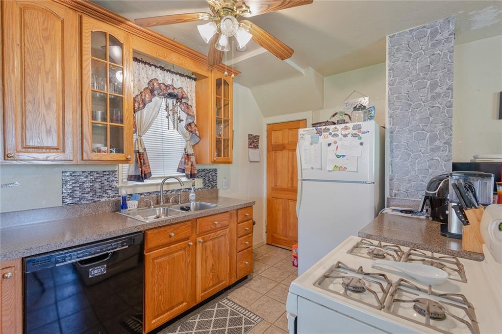 2913 Willett Road Pittsburgh, PA 15227 - Photo 13 of 25 a kitchen with stainless steel appliances granite countertop a sink stove and refrigerator