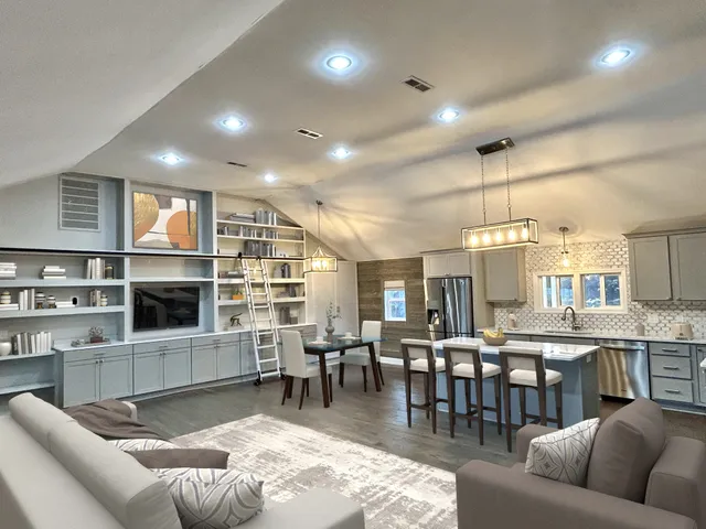 a living room with furniture a dining table and kitchen view