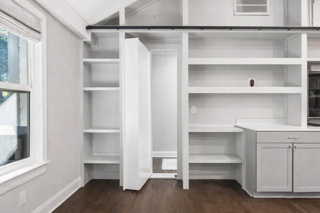 a view of walk in closet with empty racks