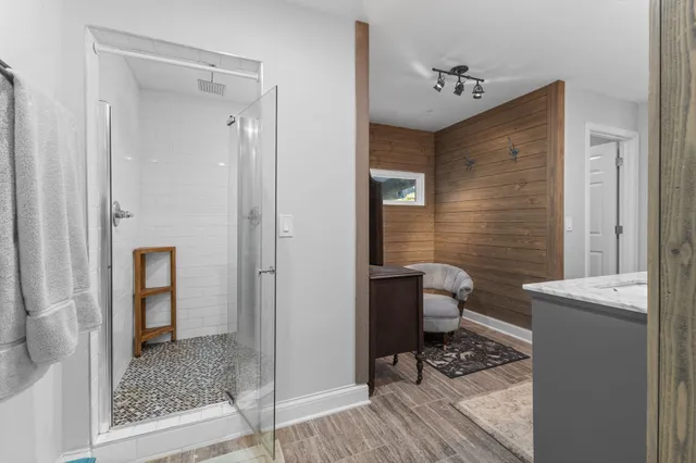 a bathroom with a granite countertop sink a toilet and shower