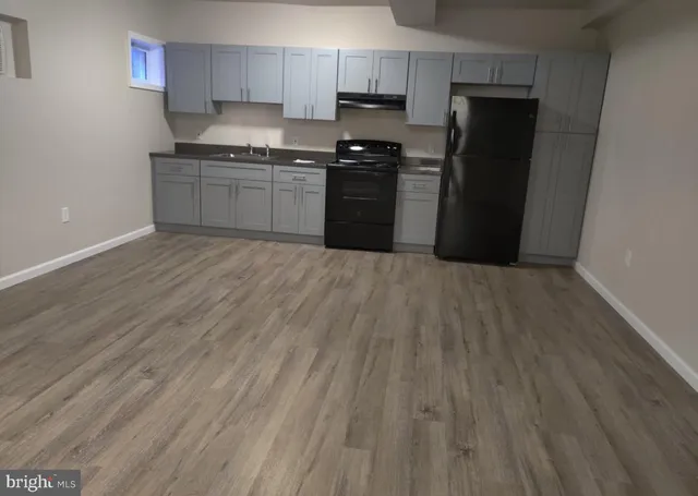 a kitchen with granite countertop stainless steel appliances a refrigerator and a stove top oven