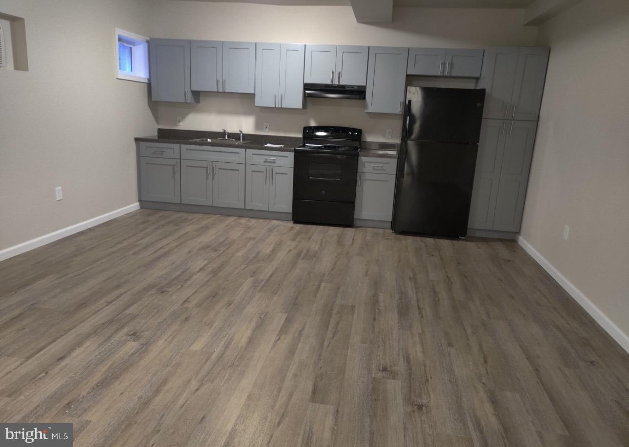 122 East Ridge Road, Unit A2 Marcus Hook, PA 19061 - Photo 1 of 5 a kitchen with granite countertop stainless steel appliances a refrigerator and a stove top oven