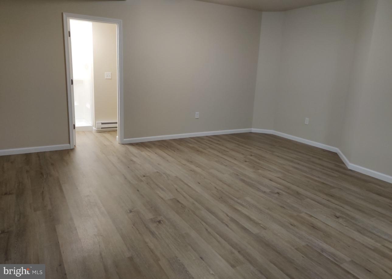 122 East Ridge Road, Unit A2 Marcus Hook, PA 19061 - Photo 2 of 5 a view of an empty room with wooden floor and a window