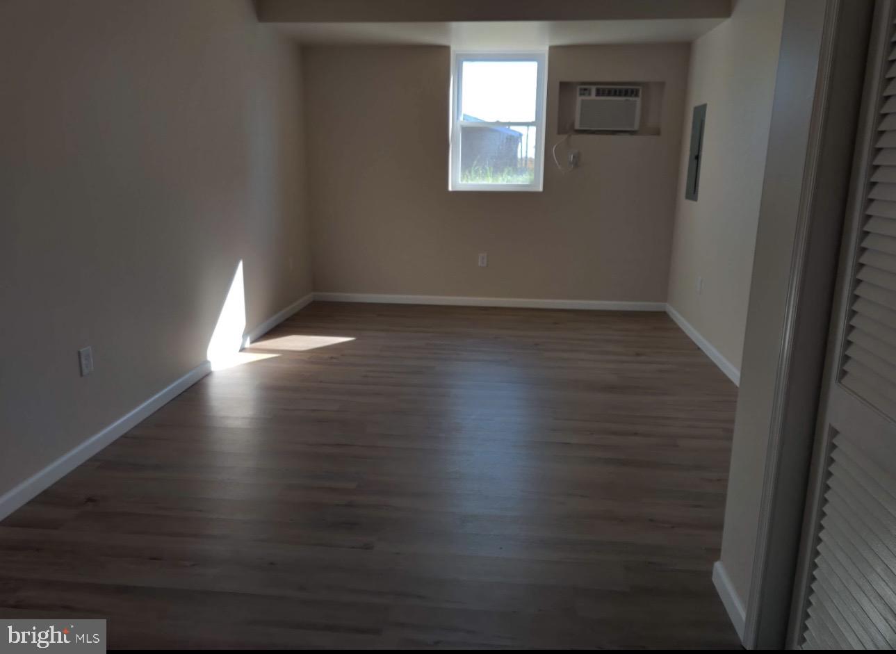 122 East Ridge Road, Unit A2 Marcus Hook, PA 19061 - Photo 4 of 5 a room with wooden floor and windows