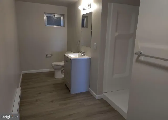 a bathroom with a toilet and a shower