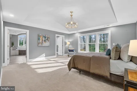 a bedroom with two beds and a large window