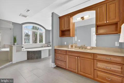 a bathroom with a granite countertop sink a toilet and a mirror