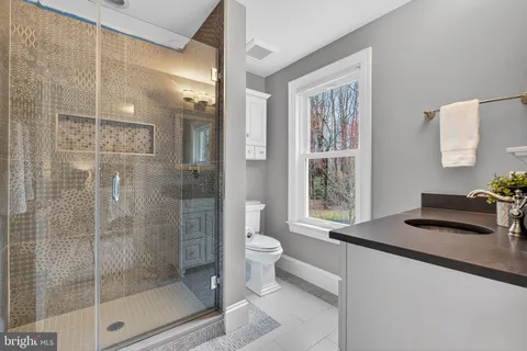 a view of a house with a big yard and large trees