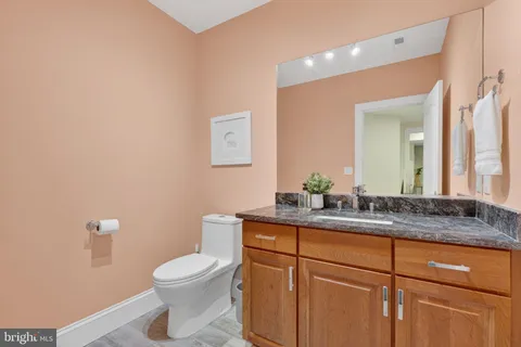 a kitchen with stainless steel appliances granite countertop a sink a stove a counter space and a window
