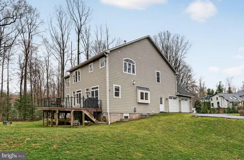 a spacious bedroom with a bed and a chandelier