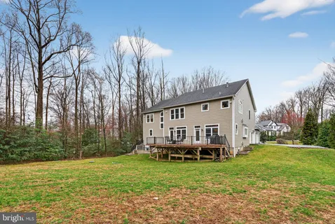 a spacious bathroom with a tub a sink and a large mirror