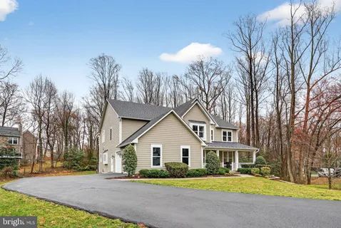 a living room with furniture and a refrigerator