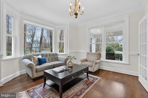 a living room with furniture a rug and a large window