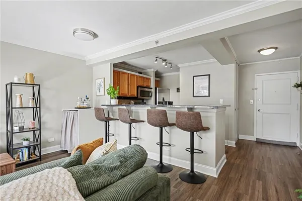 a living room with furniture a flat screen tv and a rug