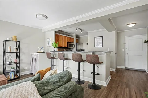 a living room with furniture a flat screen tv and a rug