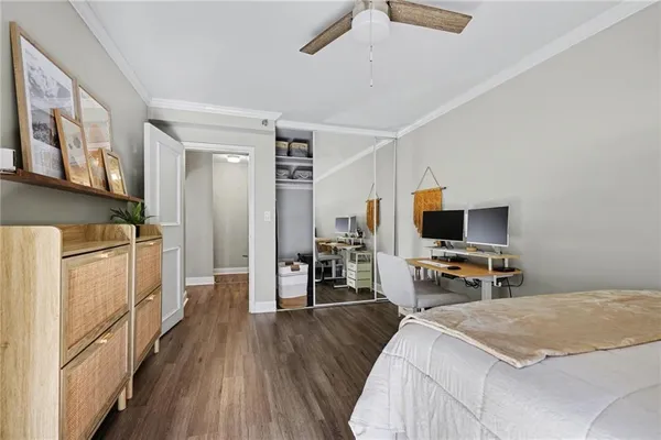 a bedroom with a bed and a flat tv screen on wall