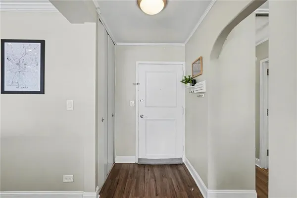 a view of a hallway with wooden floor and closet