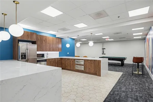 a large kitchen with a large counter top appliances and cabinets