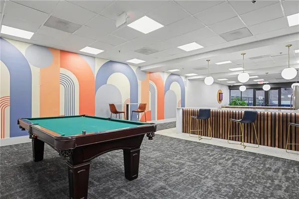 a room with lots of table chairs and a large window