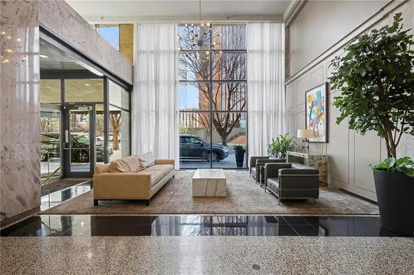 a living room with furniture and a potted plant