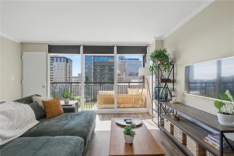 a living room with furniture and a potted plant