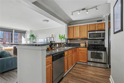 a kitchen with stainless steel appliances granite countertop a stove and a sink