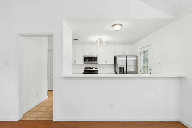 a kitchen with stainless steel appliances a refrigerator and a stove top oven