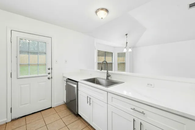 a kitchen with a sink and cabinets