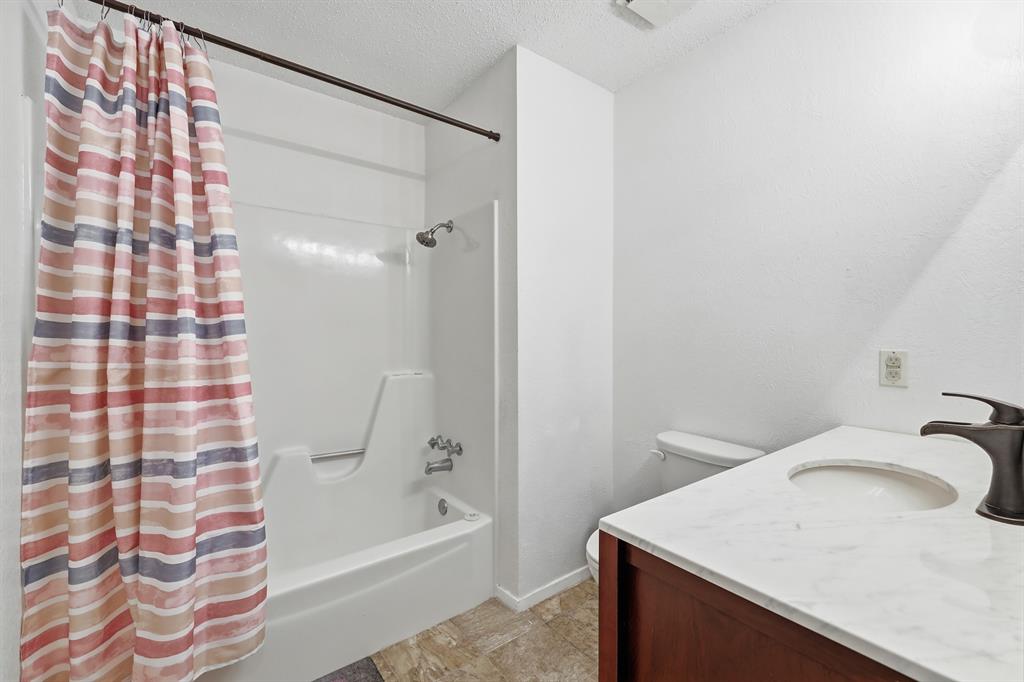 346 Meridian Street Gladewater, TX 75647 - Photo 12 of 28 a bathroom with a sink toilet and shower
