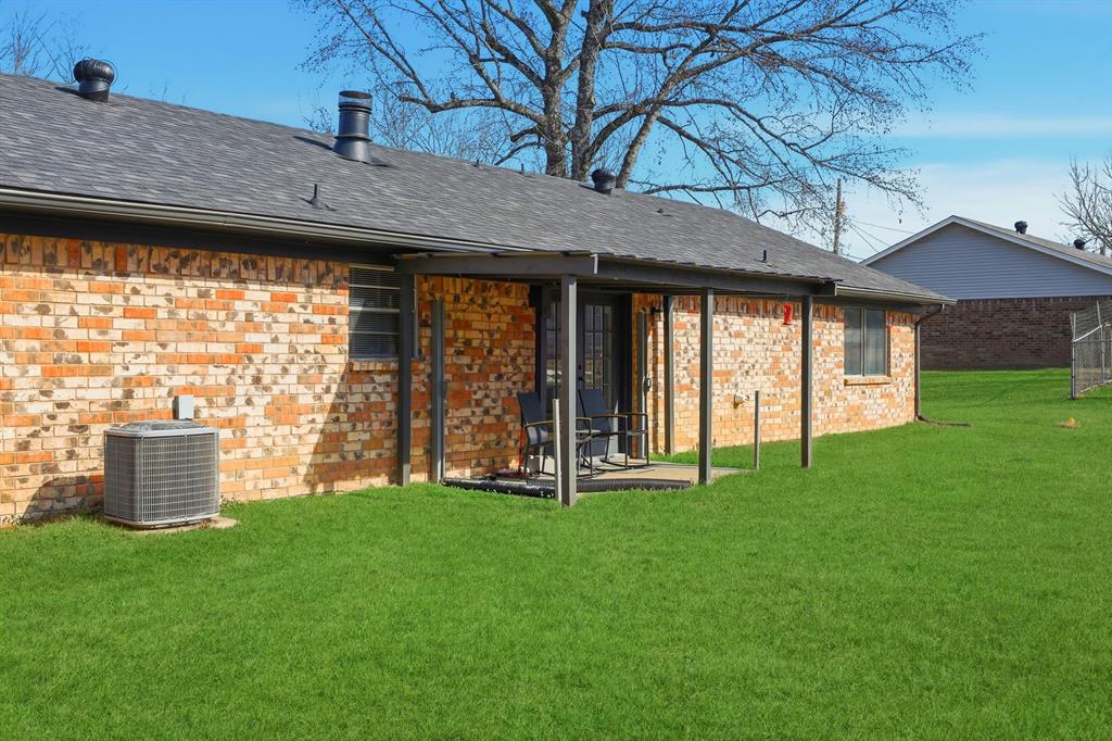 346 Meridian Street Gladewater, TX 75647 - Photo 20 of 28 a view of a house with backyard and a tree