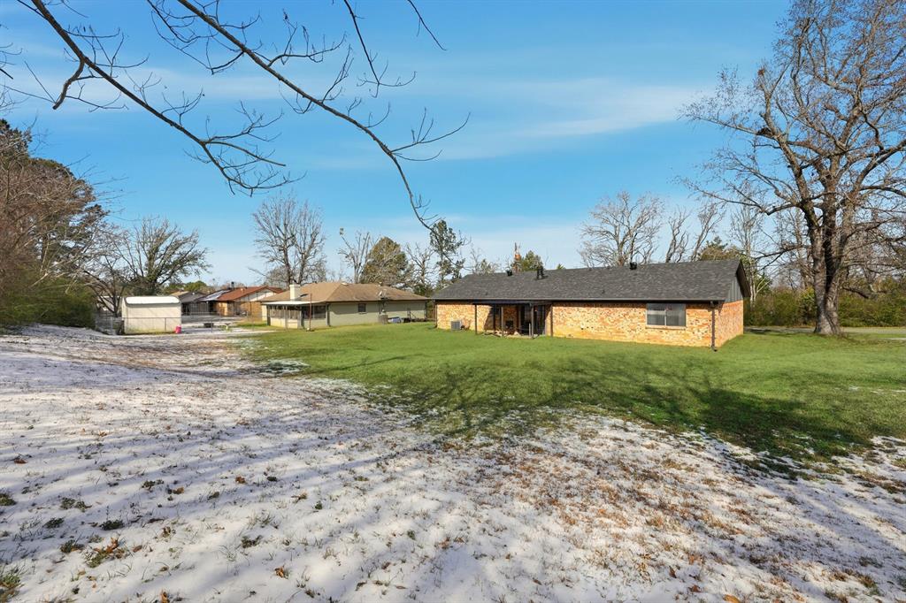 346 Meridian Street Gladewater, TX 75647 - Photo 23 of 28 a view of a yard with an outdoor space