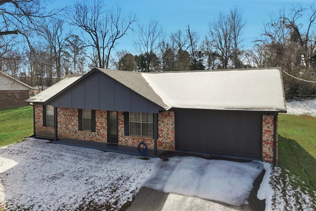 346 Meridian Street Gladewater, TX 75647 - Photo 24 of 28 a house with trees in the background