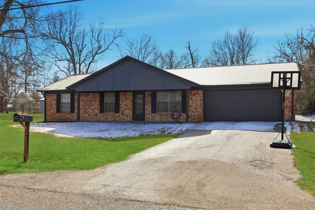 346 Meridian Street Gladewater, TX 75647 - Photo 3 of 28 a front view of a house with a yard and garage