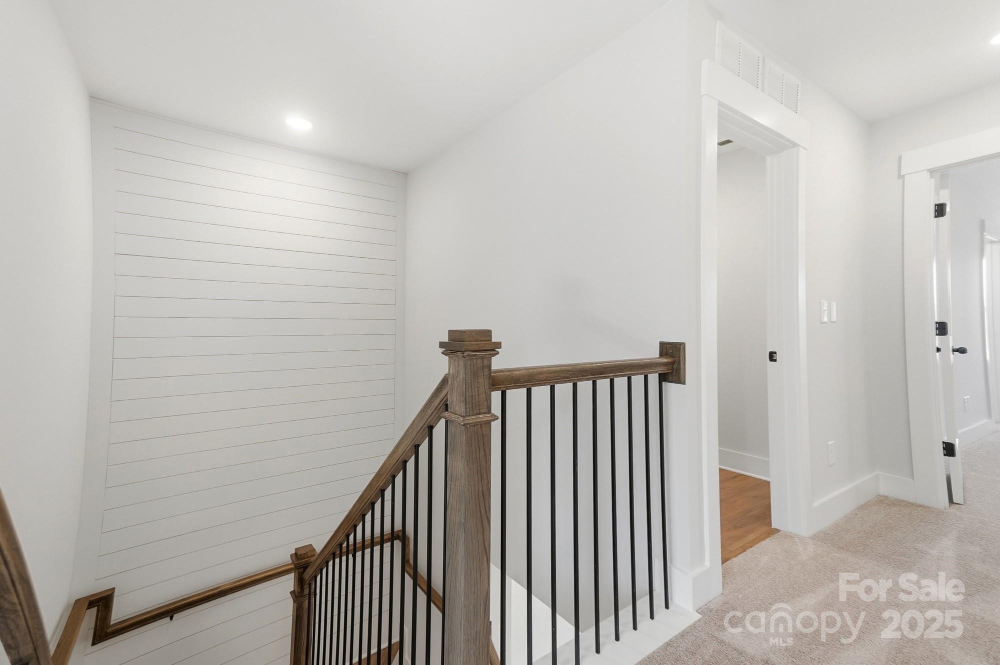 406 Limelight Road Waxhaw, NC 28173 - Photo 24 of 48 a view of a hallway with wooden floor and a bathroom