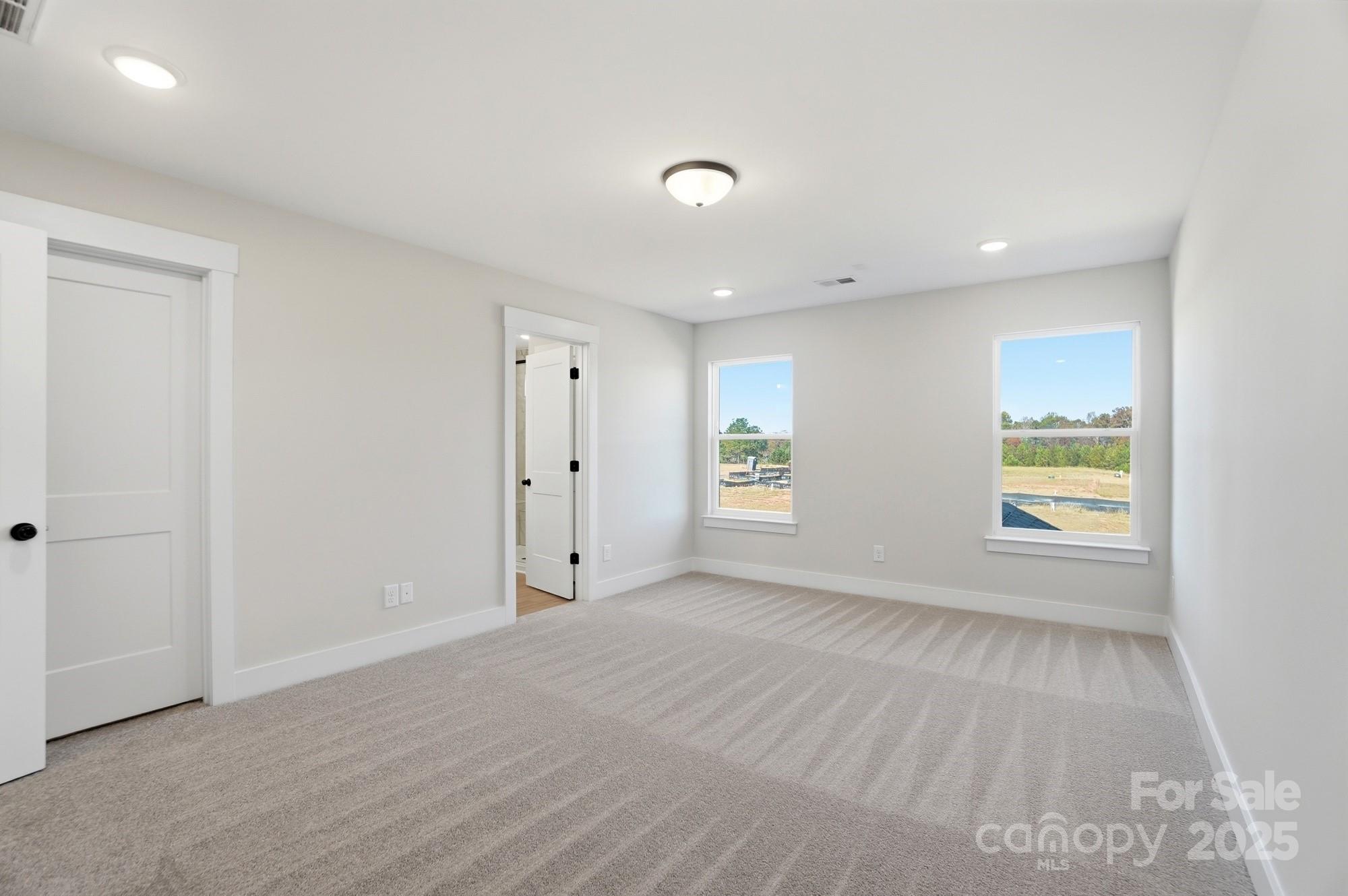 406 Limelight Road Waxhaw, NC 28173 - Photo 30 of 48 a view of an empty room with a window