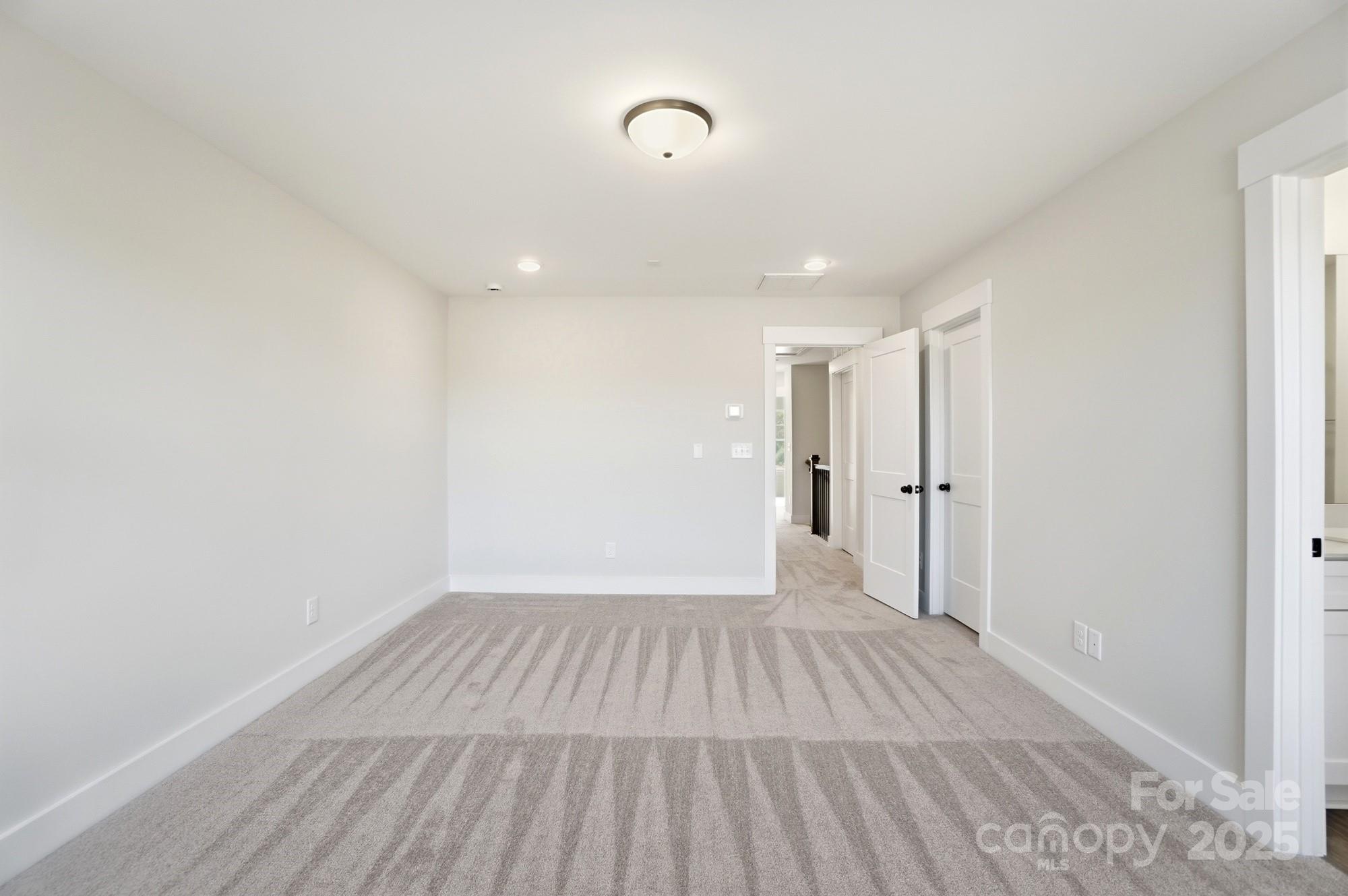406 Limelight Road Waxhaw, NC 28173 - Photo 31 of 48 a view of a room with wooden floor and white walls